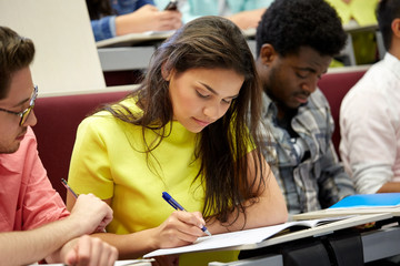 group of international students writing at lecture