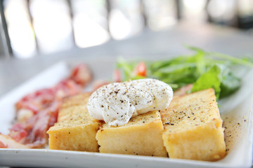 egg benedict with bacon on wood background , breakfast
