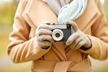 close up of woman with camera in autumn park