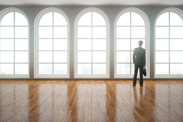 Fototapeta premium Man looking out of window