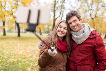 Fototapeta premium couple taking selfie by smartphone in autumn park