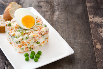 Russian salad on a rustic wooden table

