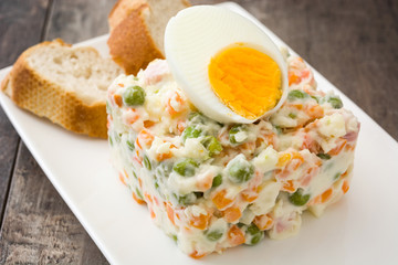 Russian salad on a rustic wooden table

