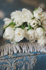 Closeup of white tulips on the coach. Shallow focus.
