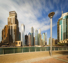 Fototapeta na wymiar Panoramic view of Dubai Marina bay with yacht and cloudy sky, Dubai, UAE.