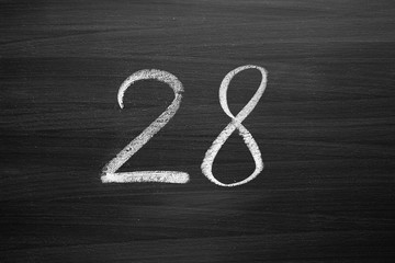 number twenty eight enumeration written with a chalk on the blackboard