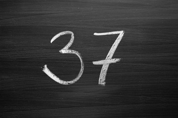 number thirty seven enumeration written with a chalk on the blackboard