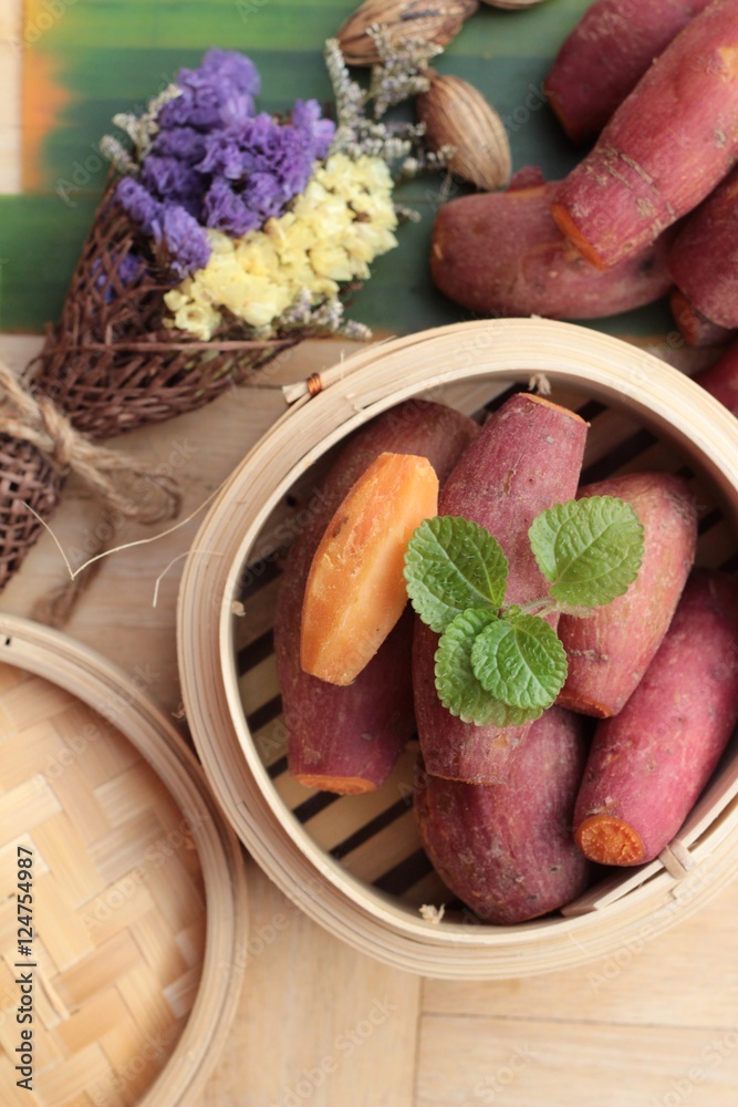 Wall mural sweet potato boiled is delicious on wood background.