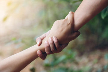 Friends holding hands pulled Help