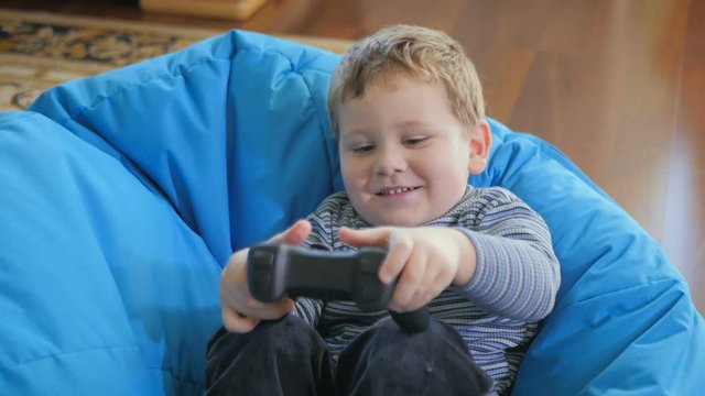 Little happy boy playing on the playstation