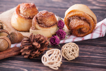 Cinnamon bun on wood background