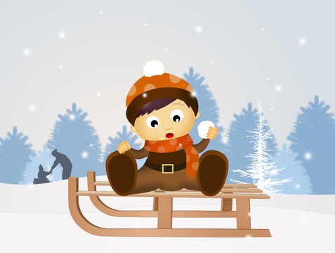 child on sleigh in winter