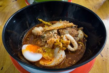 Thai cuisine : Noodle Tom Yam, noodles with vegetable pork and hot spicy soup served with boiled egg, taste is hot, spicy and sour.