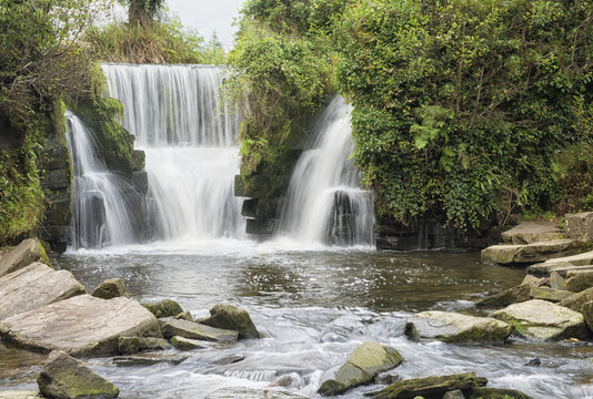 Landscape image of a waterfall in Penllegare Woods 