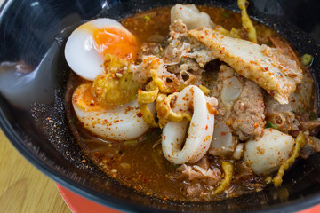 Thai cuisine : Noodle Tom Yam, noodles with vegetable pork and hot spicy soup served with boiled egg, taste is hot, spicy and sour.