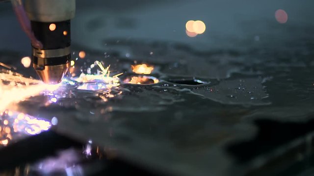 Plasma laser cutting metal sheet with sparks