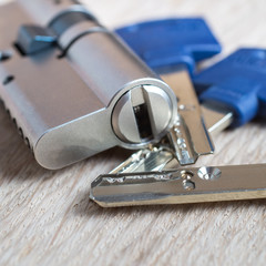 door lock with keys on wooden surface