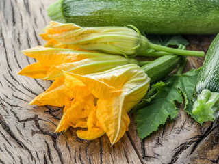 Zucchini flowers on a old wooden table.