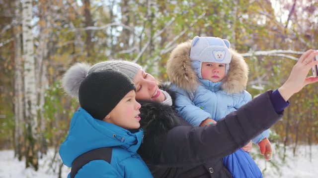happy family making a selfie in winter Park