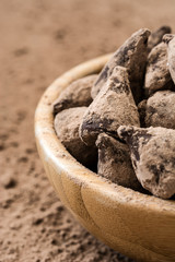 Homemade chocolate truffles in a wooden bowl


