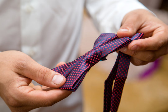 Man Fixing His Tie