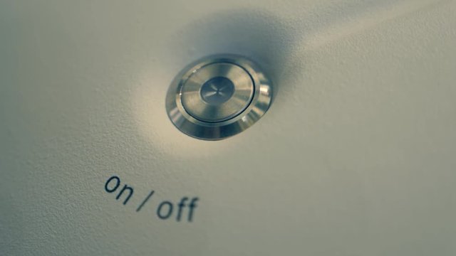 Metallic button on-off  is recessed on the white surface of the device in order to avoid accidental activation