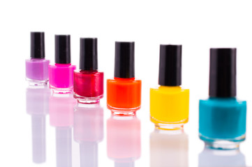 Many multi-colored nail polish. On white, isolated background.