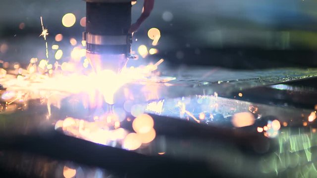 Plasma laser cutting metal sheet with sparks