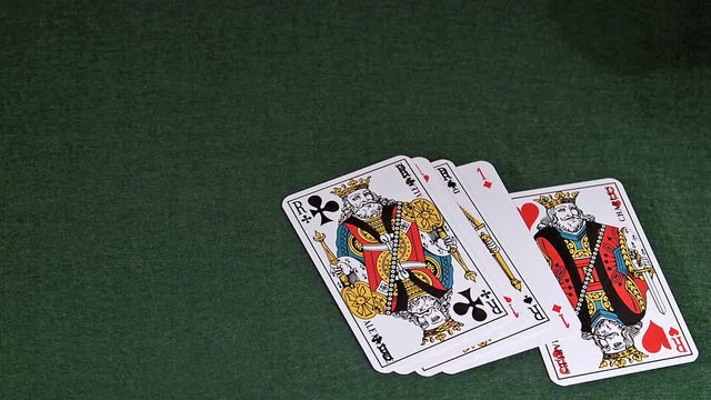 Playing Cards, Two Aces and Three Kings falling on Green Baize, Slow Motion