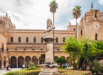 Fototapeta premium Statue on the background of famous cathedral in Monreale near Palermo, Sicily.