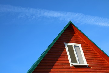 Plastic window of a modern summer cottage against a blue sky