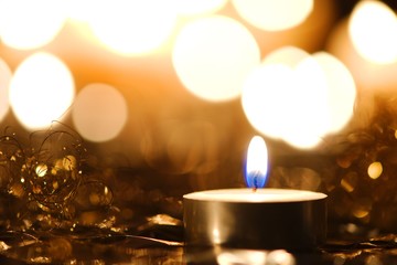Christmas candlelight decoration against blurred background of bright lights