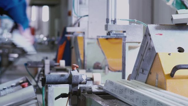 PVC Windows and Doors Manufacturing. PVC sections of windows and doors in a single frame - finishing process, releasing small window for the next step.