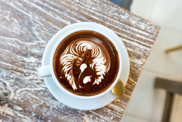 cup of coffee latte on the wooden desk