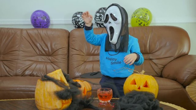 Little boy in scream mask are scaring on Halloween