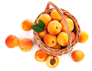 Fresh apricots with green leaf in wicker