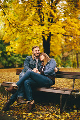 Fototapeta premium Young couple in the autumn park