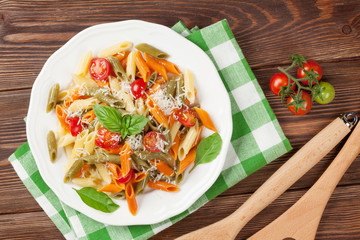 Colorful penne pasta with tomatoes and basil