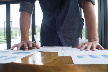 Businessman at work. Holding pencil in his hand. Architectural p