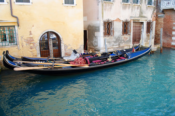 Fototapeta na wymiar Gondolas in Venice in the narrow channel, Italy.