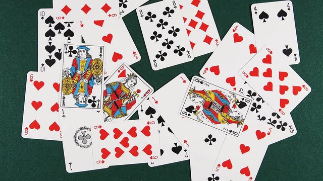 Playing Cards Falling against Green Background, Time Lapse