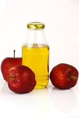 Fresh apples and a bottle of apple cider vinegar.