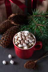 Hot chocolate or cocoa with marshmallows on gray background. Christmas presents. Holiday concept.