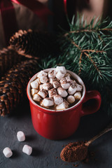 Hot chocolate or cocoa with marshmallows on gray background. Christmas presents. Holiday concept.