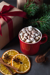 Hot chocolate or cocoa with marshmallows on gray background. Christmas presents. Holiday concept.
