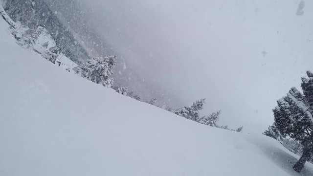 SELFIE CLOSE UP: Snowboarder riding fresh powder and crashes down into snow