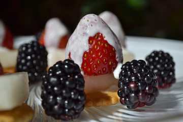 Christmas fresh fruit dessert. Black and red colors.