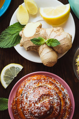 Baked bun, ginger root and lemon on the plates