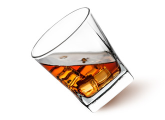 Whiskey with ice in a tilted glass