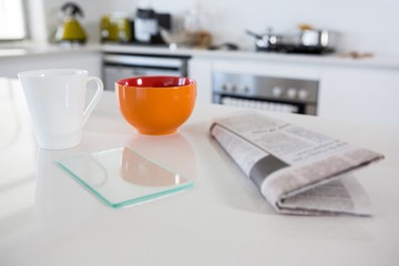 Breakfast bowl with coffee mug and newspaper